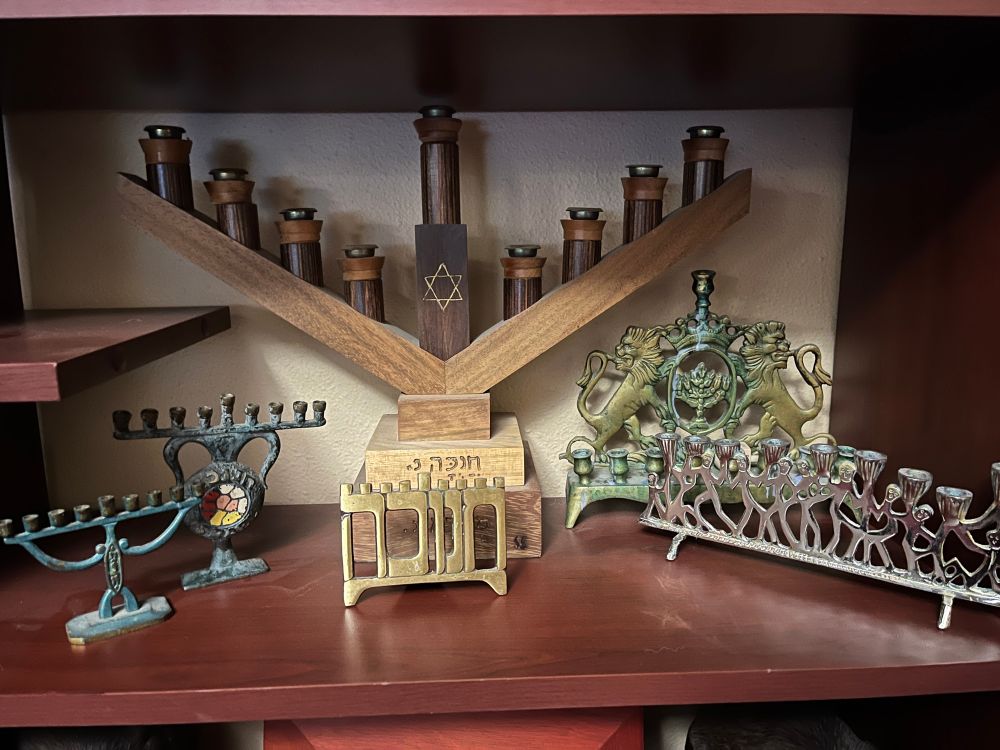 Our shelf with family menorahs … three small ones that take birthday candles, two of which are at least 70 years old. One really big one in the back. A family heirloom handed down from my great grandmother at the back on the right. 