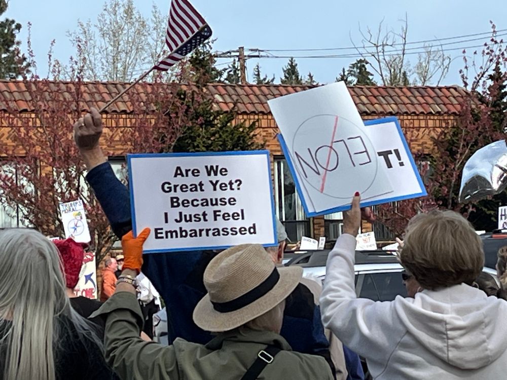 Sign says “are we great yet? Because I just feel embarrassed”