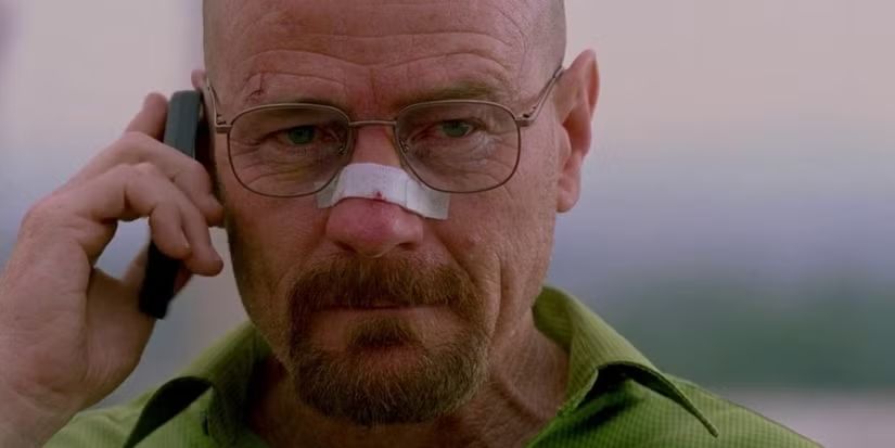 Walter White making a call with a bandage on his nose.