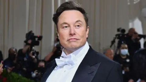 infamous Nazi billionaire Elon Musk looking sexually satisfied by sharting himself. he sucks worse