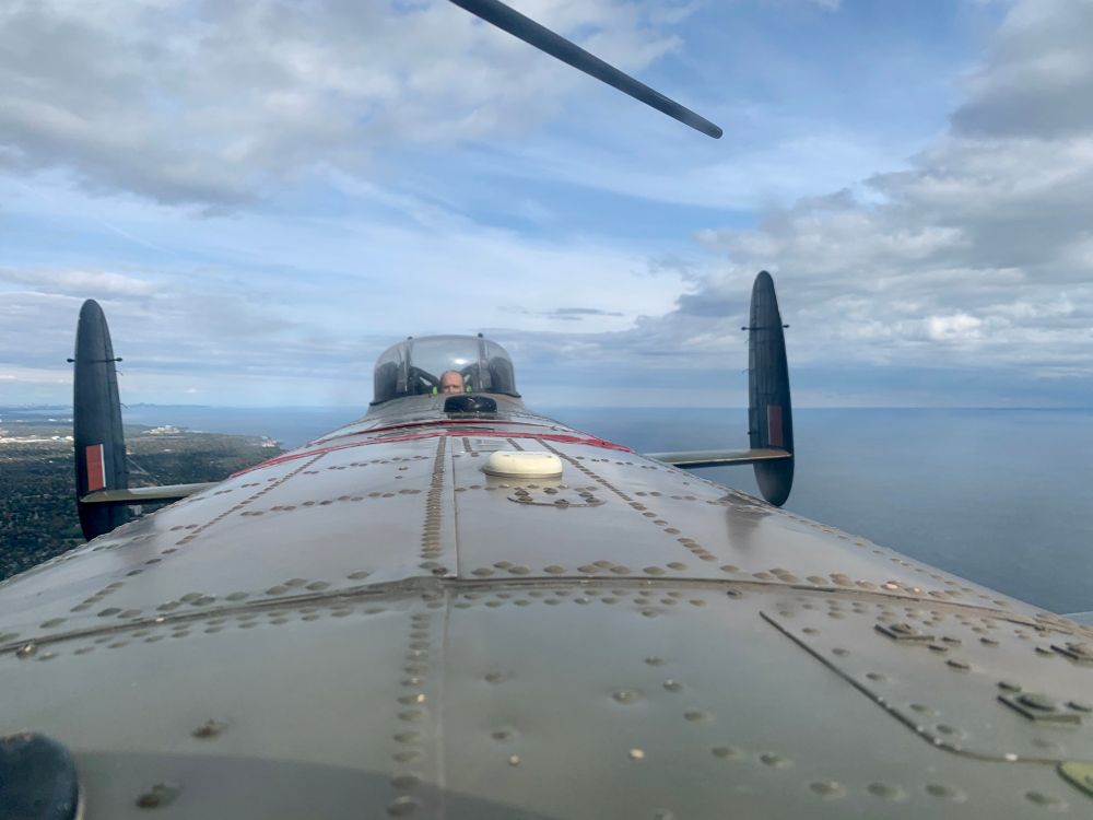 Looking aft towards the tail of an Avro Lancaster in flight. 
