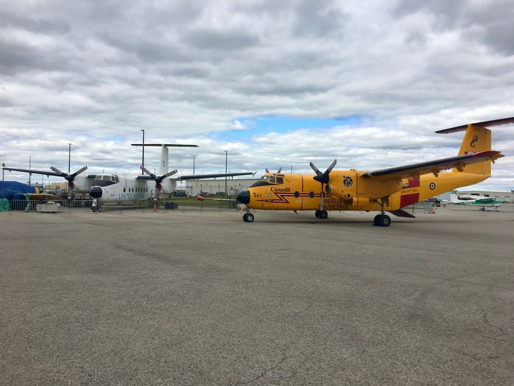 Two RCAF DHC-5 Buffalo airplanes, one in modern Search and Rescue markings and the other in vintage UN service markings. 
