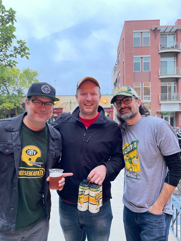Aaron Nagler, Tim Backes, and Corey Behnke carrying the G. 