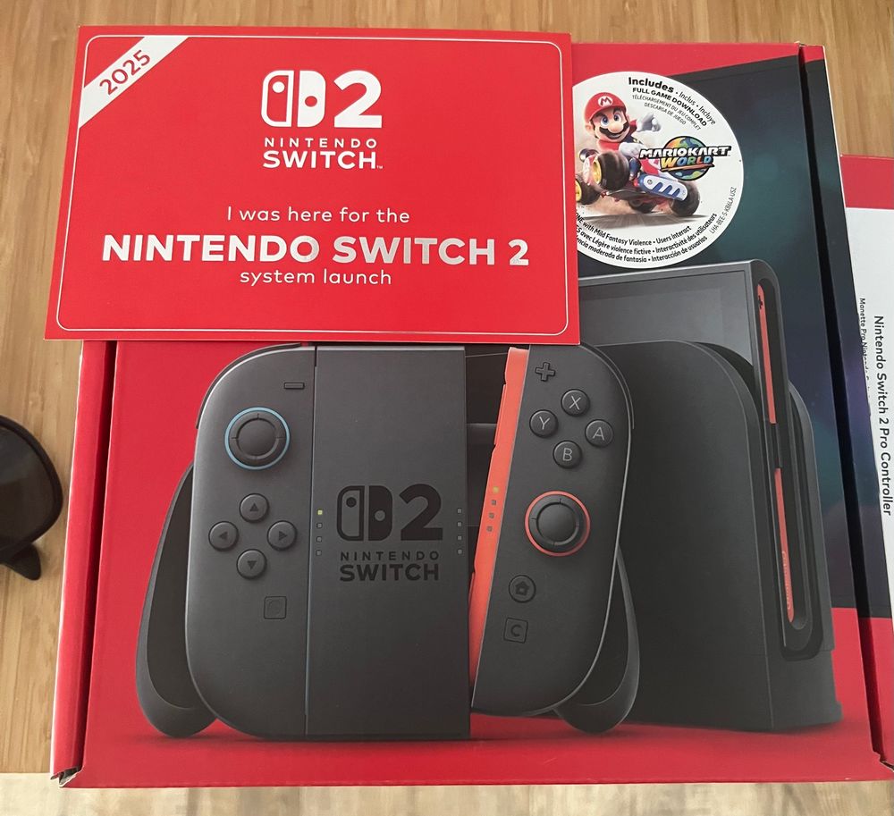 Photo of the Switch 2 box on my counter. There is also a post card that reads “I was here for the Nintendo Switch 2 system launch”.