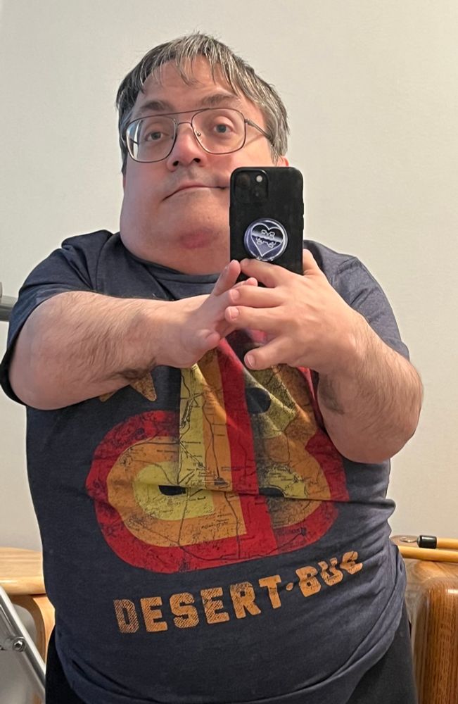 Me and a black, red, orange, and yellow desert bus T-shirt.