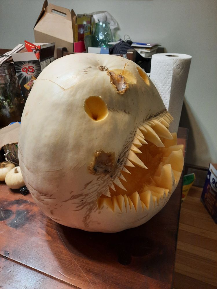An ugly white gourd carved to look like an anglerfish seen in profile