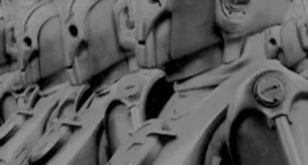 a row of robots are lined up in a row in a black and white photo .