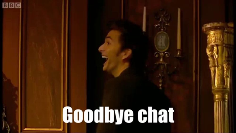 a man in a suit stands in front of a fireplace with the words goodbye chat on the screen