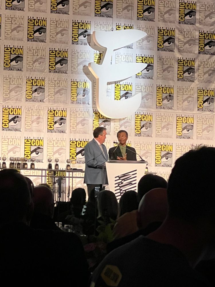 Phil LaMarr and Bill Morrison announcing the 2025 Eisner Awards in San Diego
