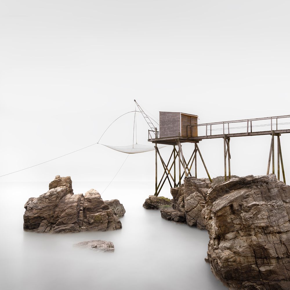 A fisherman's hut on the rocky cliffs on the wild coast of Brittany, France. The minimalist effect was achieved by long exposure using an ND filter.