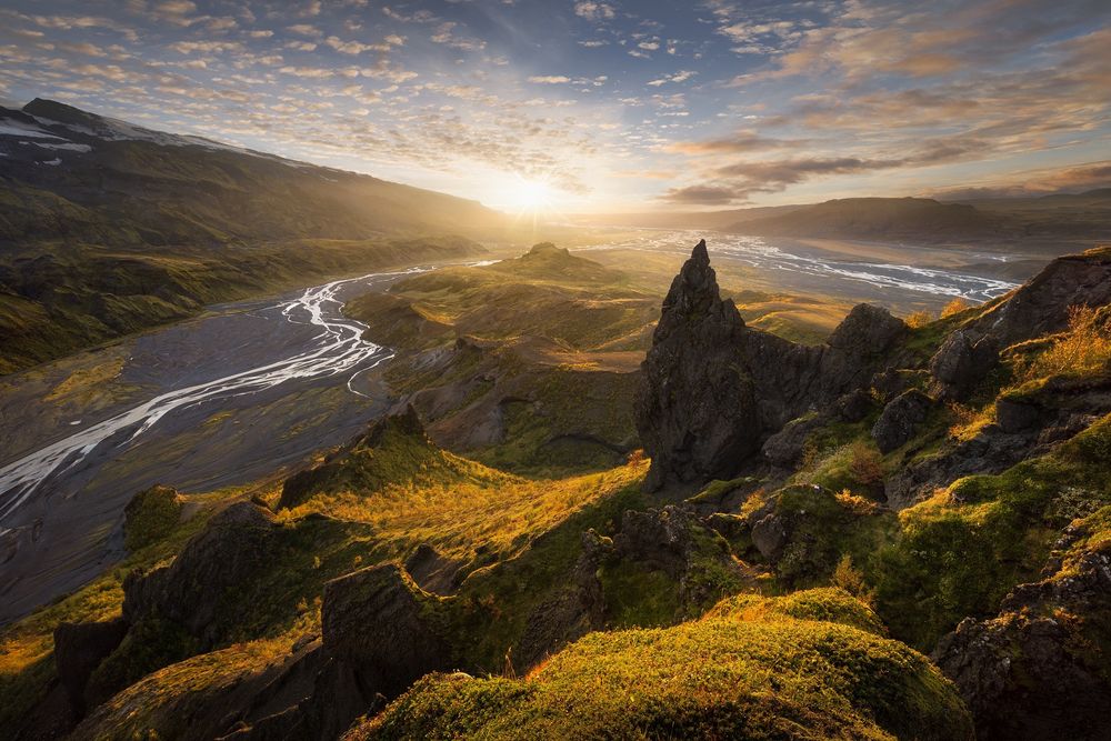 View of the confluence of glacial rivers in the mountainous interior of Iceland at autumn sunset.