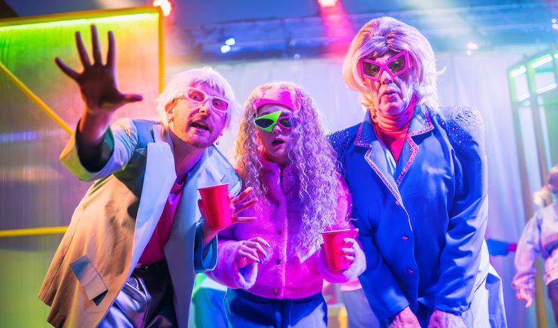 Michael Dylan, Rebekah Lumsden and Graham Crammond peer into the lense, wearing strange 3D glasses.