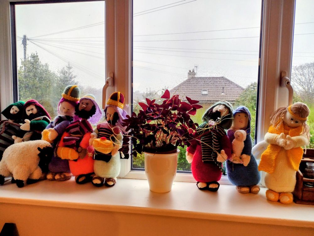 knitted nativity figures on a windowsill 