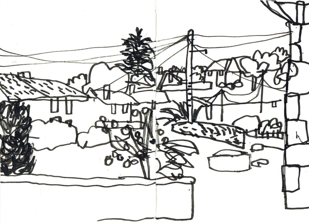 A monochrome ink drawing of a Spanish landscape showing buildings, a garden, trees and telegraph lines.