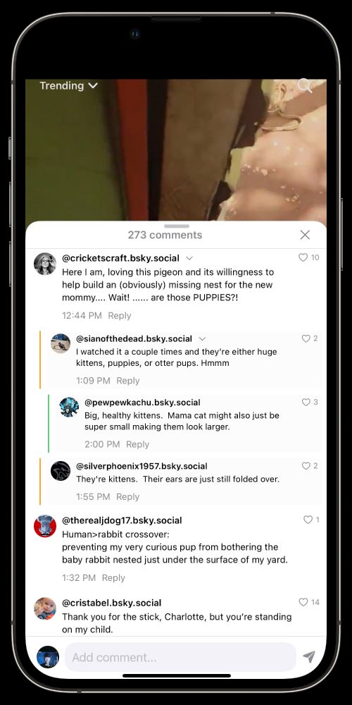 iPhone screen in Skyswipe’s Trending feed showing the comments panel with 273 comments. The top of a video is visible behind a white overlay listing comments. Nested replies appear with colored sidebars; each comment shows username, timestamp, and a heart icon for likes.