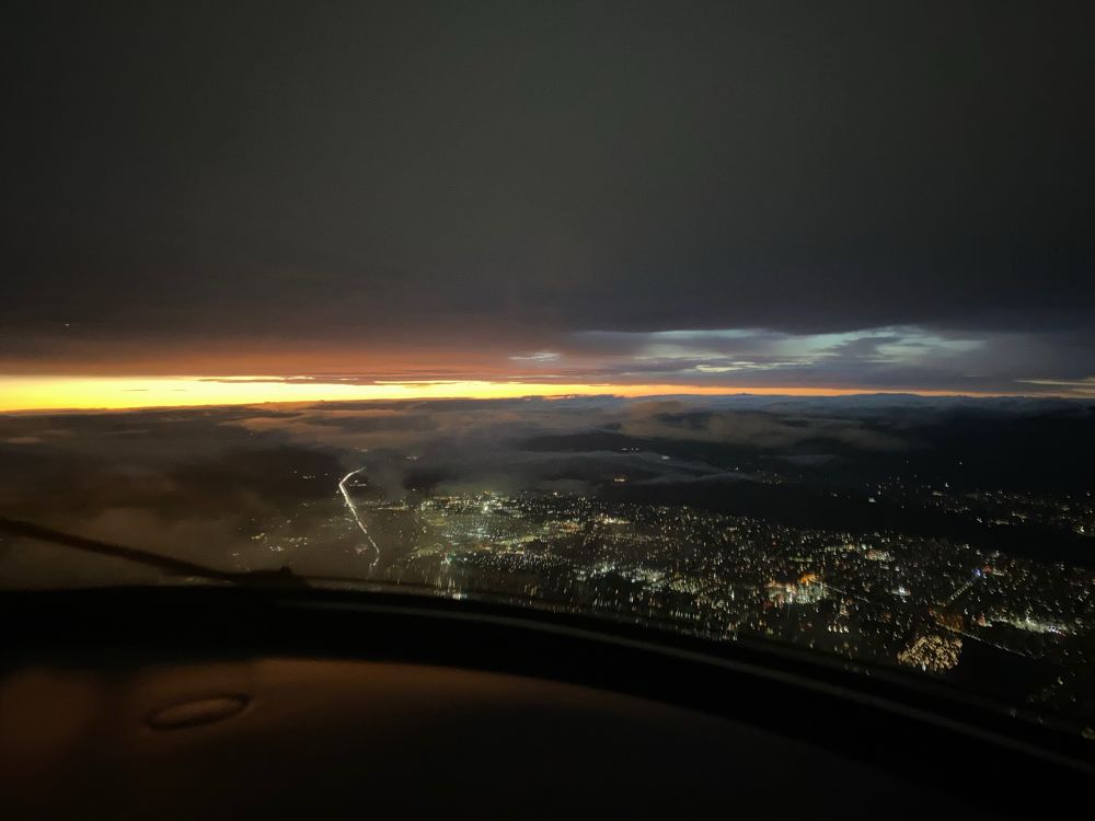 View from airplane of large city at twilight.