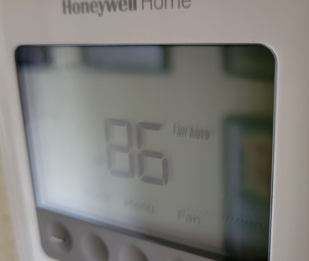A thermostat displaying that it's 86 freaking degrees in my house.