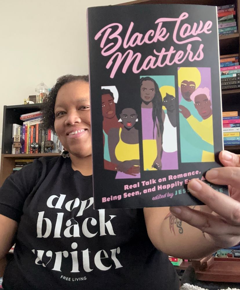 Photo of a light skinned Black woman wearing a shirt that says “Dope Black Writer” holding up a print copy of the book Black Love Matters