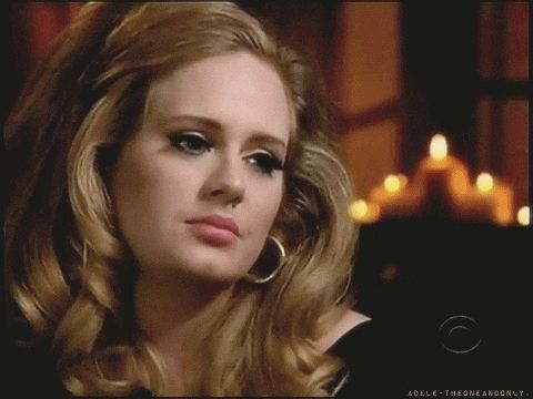 Adele blinks and stares in annoyance.