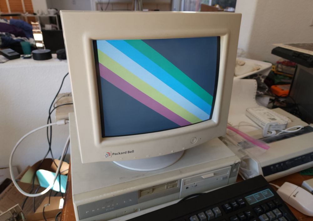 A beige desktop with a CRT, showing the Disability pride flag