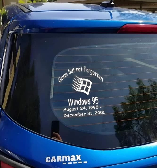 A sticker on a blue hatchback, with the Windows logo and 