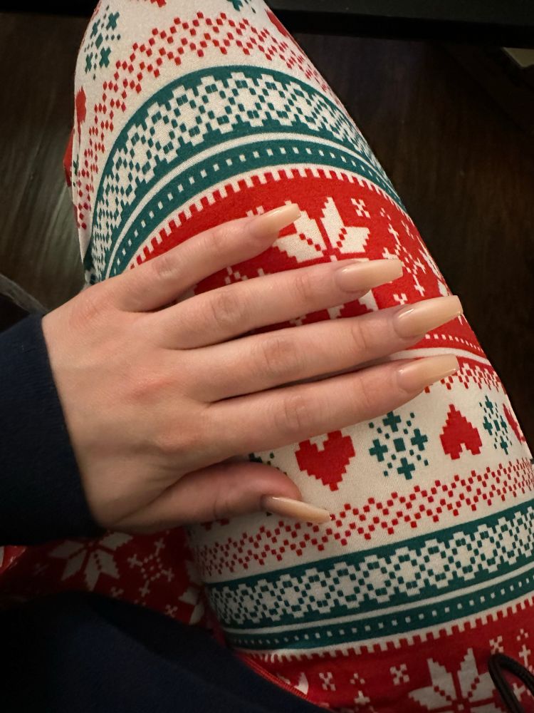 Picture shows long peach colored coffin shaped nails 