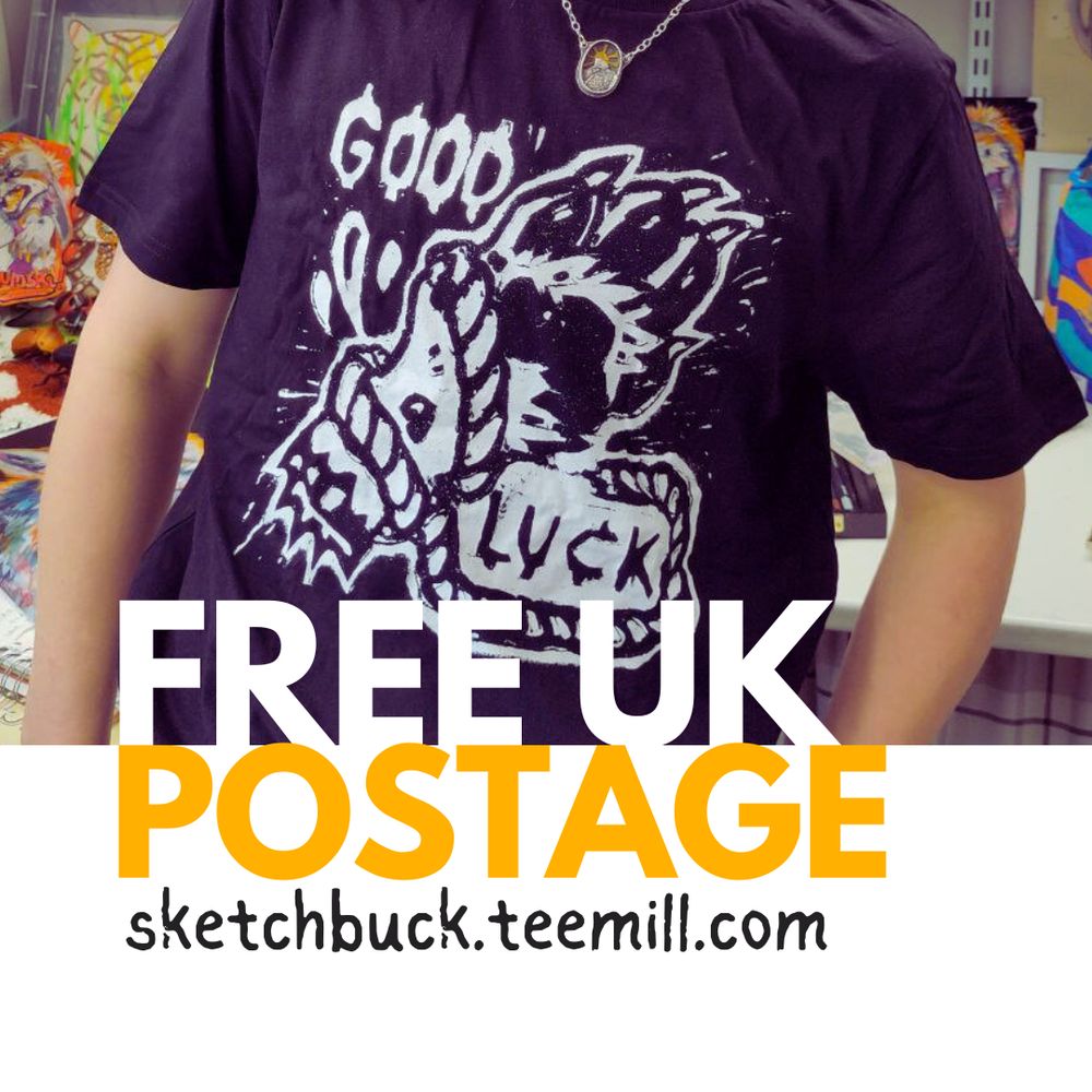 A photo of Hoggy wearing a black coloured t-shirt with a linocut design of a lucky wolf's paw bound in rope, the text reads 'Good Luck'. Below in bold contrasting white and yellow text reads - Free UK postage. sketchbuck.teemill.com