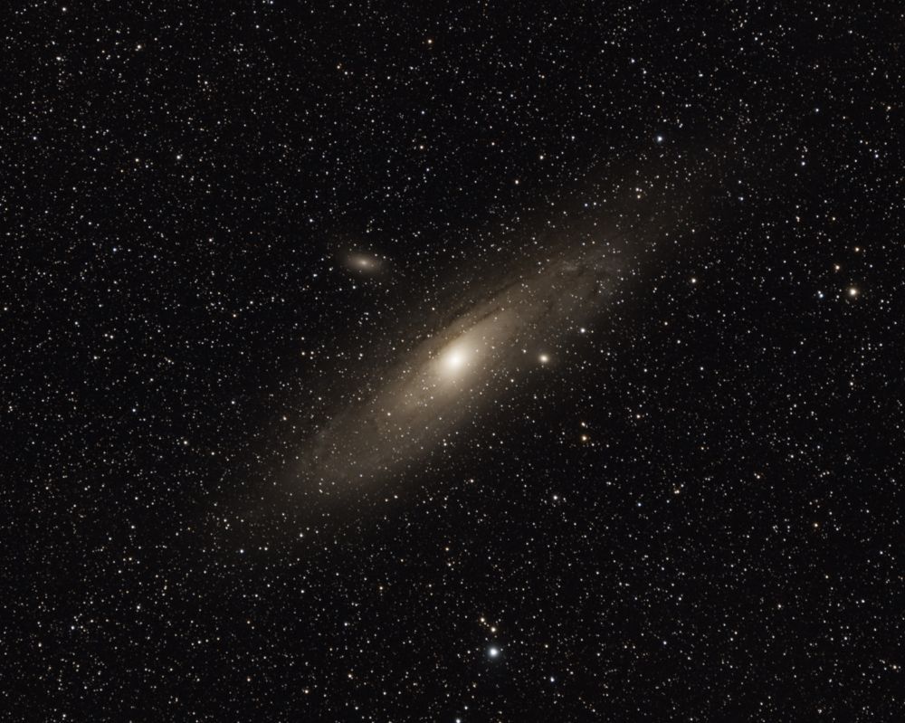 M31 the Andromeda Galaxy, a large galaxy brightly lit against the backdrop of stars, a small hazy galaxy is directly above the galaxy.

Photo Credit: Richard Ferro