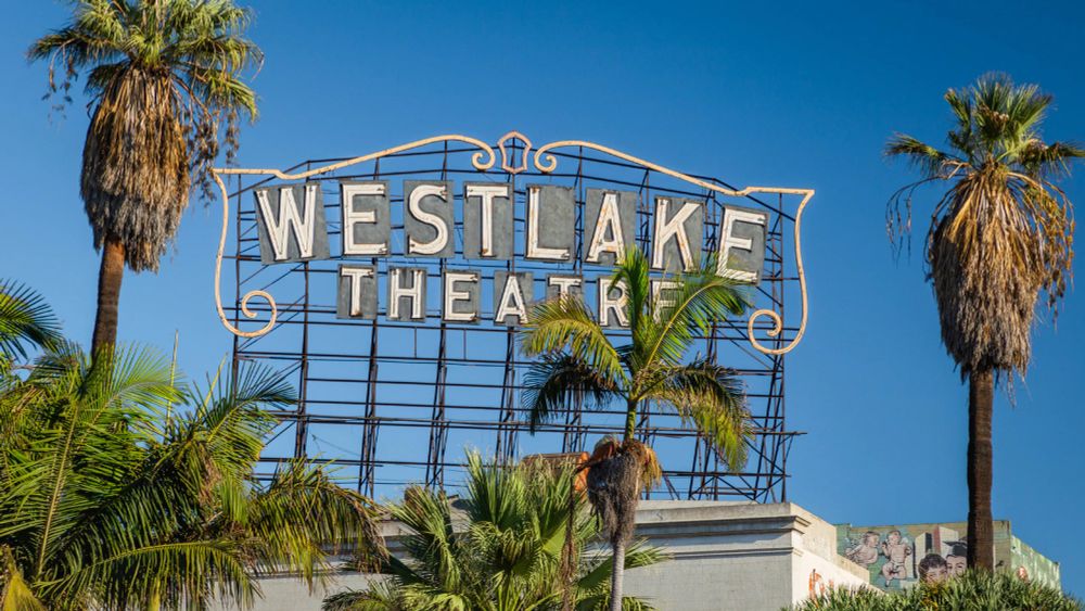 Westlake Theater Sign surrounded by palm trees