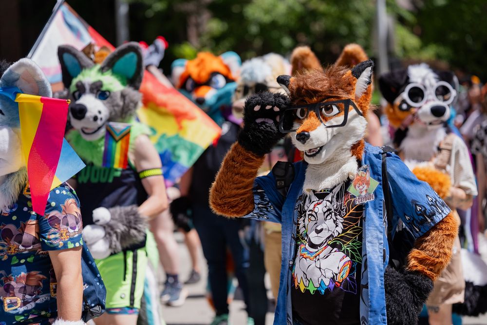 Myself and multiple other fursuiters marching in the Seattle Pride Parade 2025