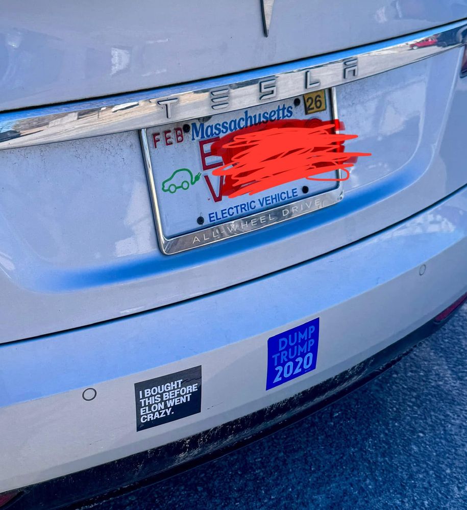 A tesla with the bumper sticker "I bought this before Elon went crazy. Which is a lie because Elon was always crazy and you knew it.