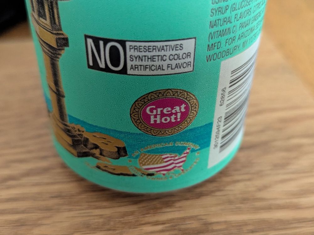 Close-up of the note on the side of a can of Arizona green tea, proudly announcing that it is "Great Hot!"