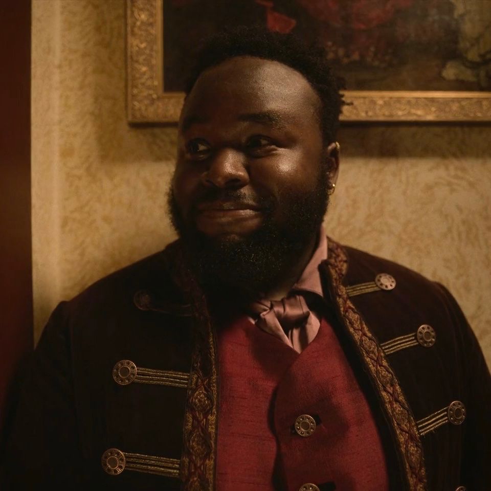 Samson Kayo as Oluwande Boodhari in Our Flag Means Death, smiling 