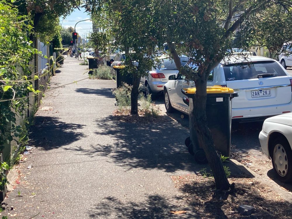 Suburban street with three yellow lidded bins and zero purple lidded bins
