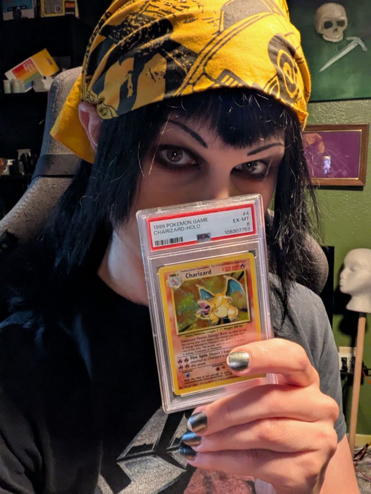 goth bitch with a PSA 6 1999 holo Charizard card