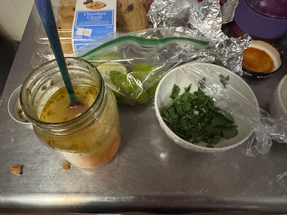 My pickled jalapeños and carrots, freshly cut limes, and cilantro on a counter