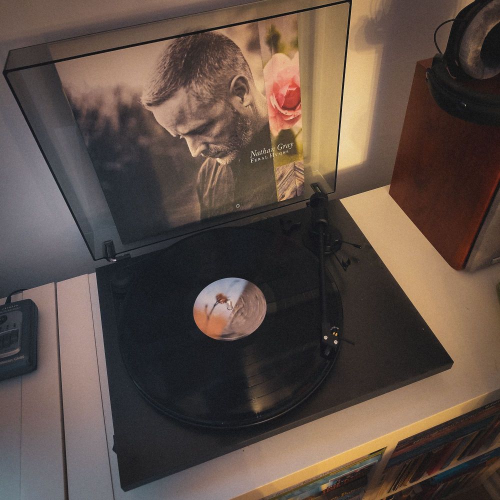Feral Hymns by Nat Gray spinning on a record player.