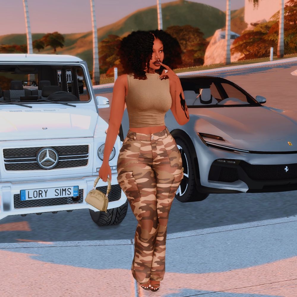 A sim posing in-front of her two cars in a matching outfit.