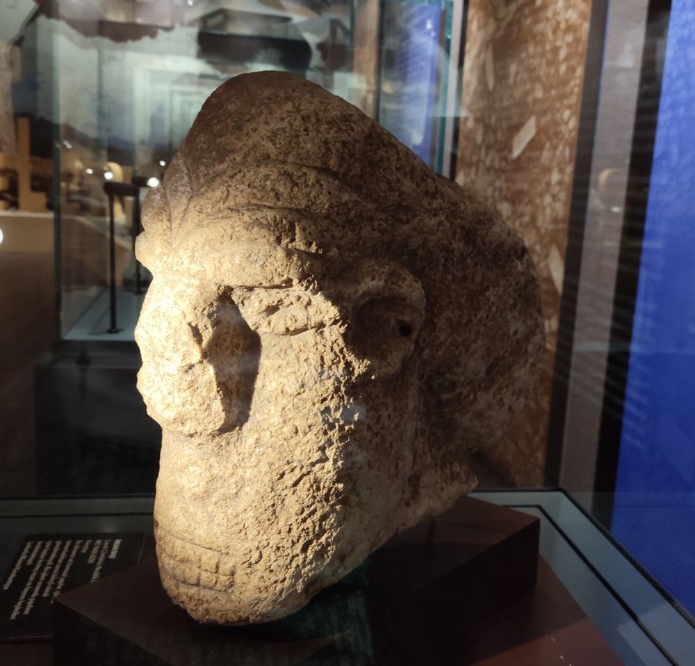 A crude human head.of.limestone, ears eyes a big nose and a mouth with exposed teeth were featured.