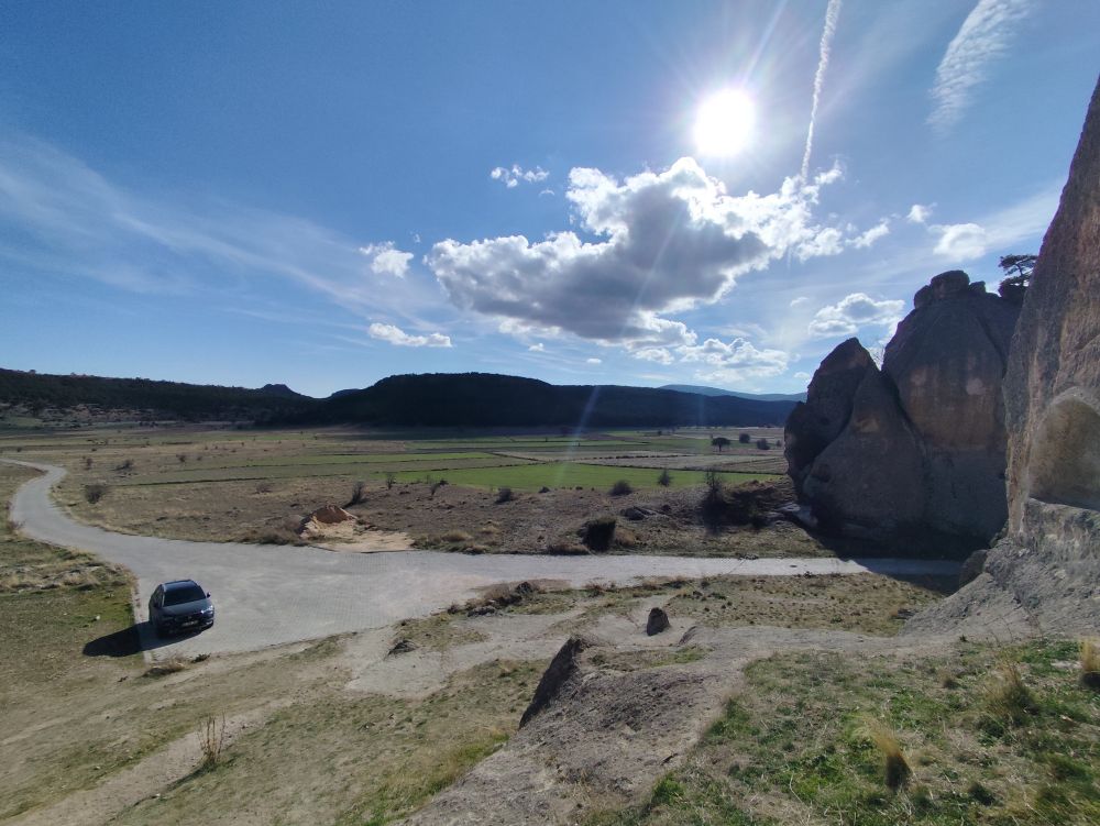 The valley beyond with sowed fields extending till the forest hills