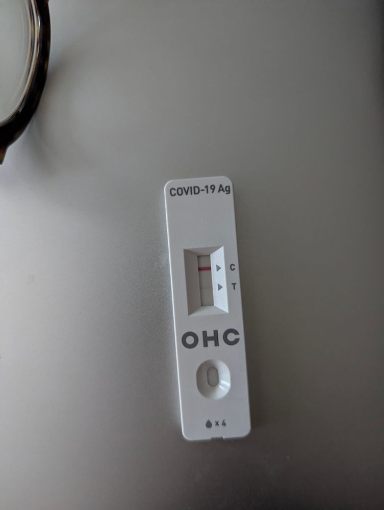 Picture of a COVID-19 Rapid Antigen Test showing a slight positive.