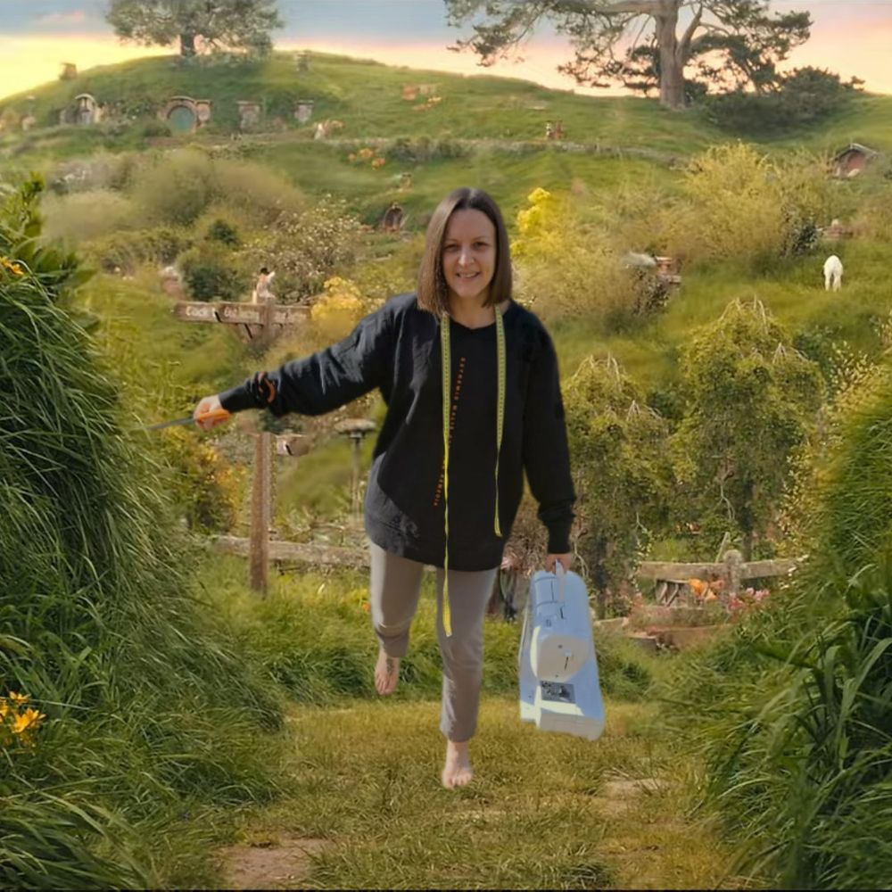 Photoshopped picture of the "I'm going on an adventure" scene from The Hobbit, instead of Bilbo, it's a woman with a sewing machine in her left hand, scissors in her right hand and measuring tape around her neck.