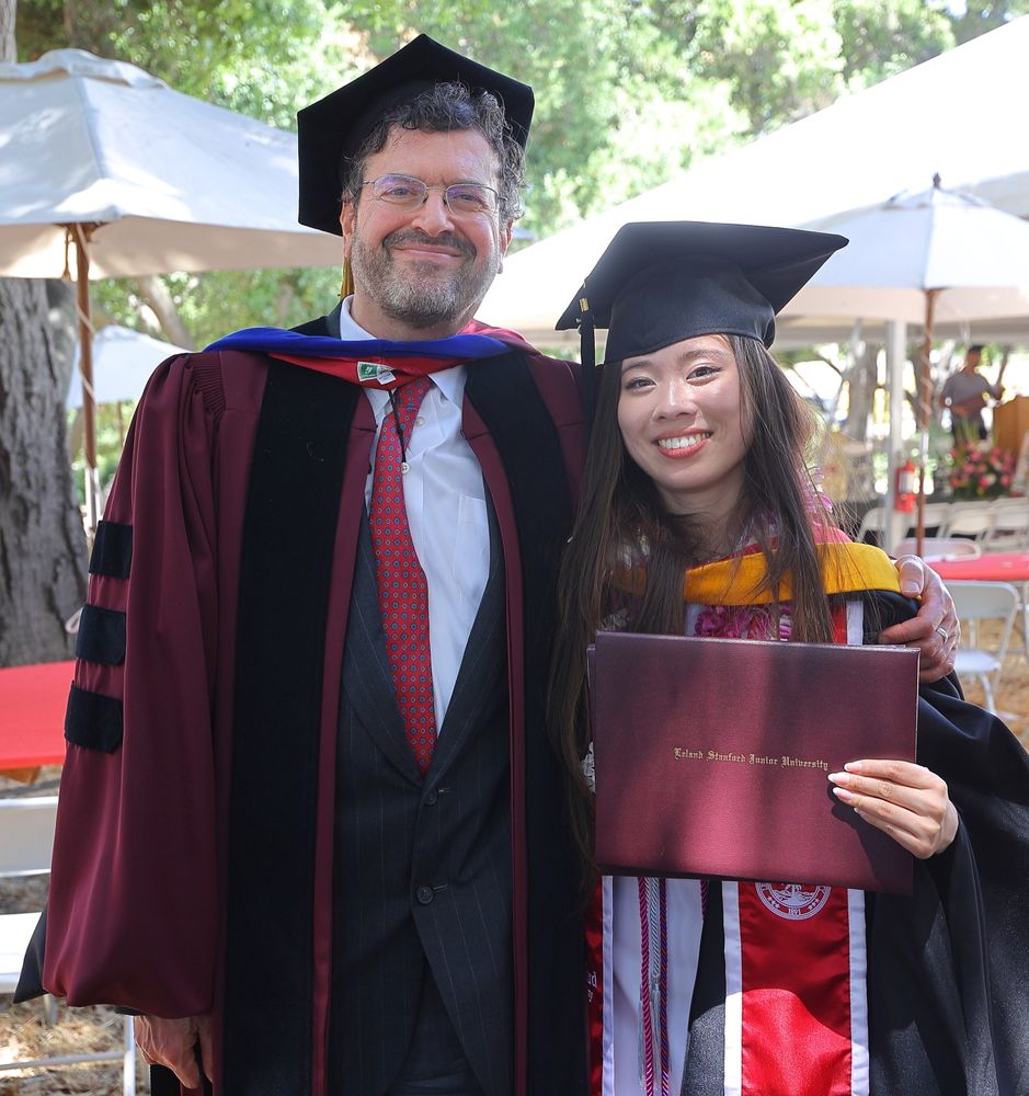 Faculty director of the BA program smiling with a graduate