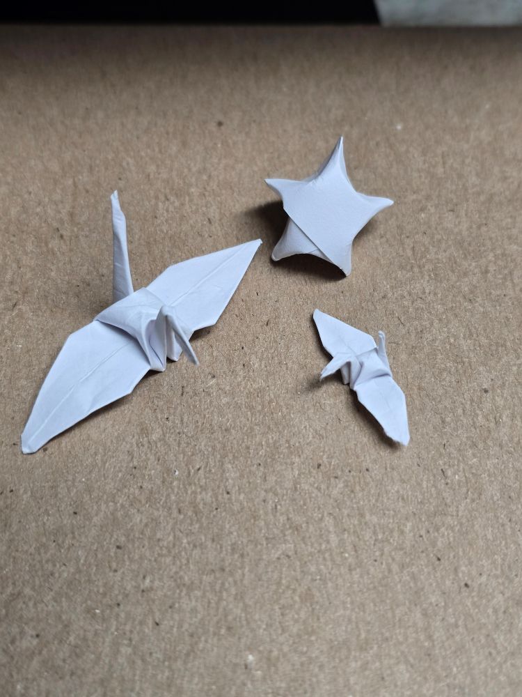 Two paper cranes and a paper star