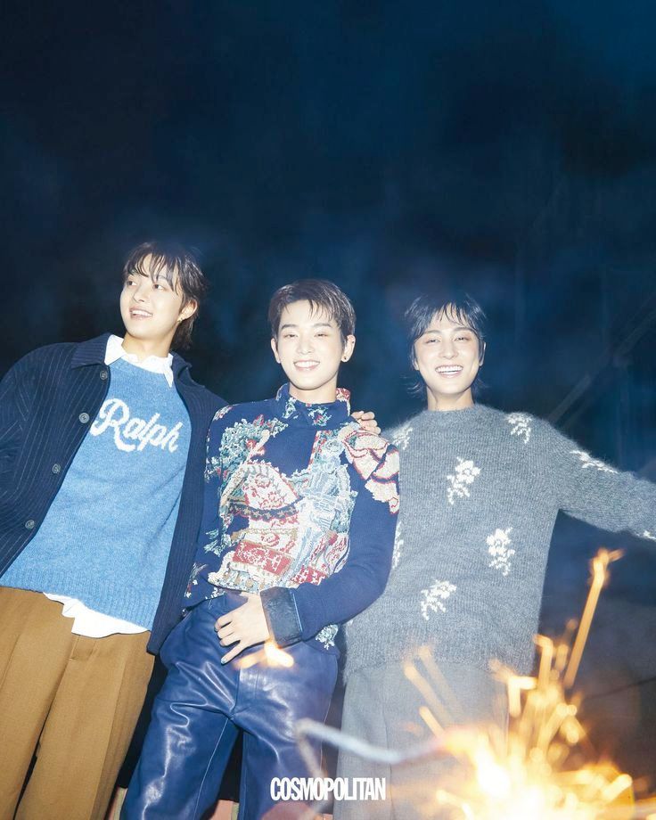 ej harua and taki all smiling w a sparkler in front of them