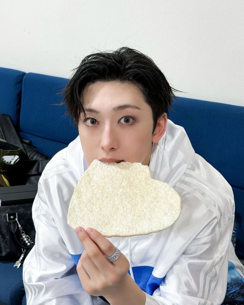 fuma taking a bite out of a white pastry/cracker thing shaped like a heart