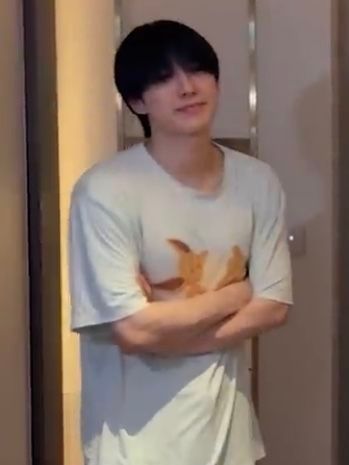 blurry pic of fuma w eevee sleep shirt on and his arms crossed