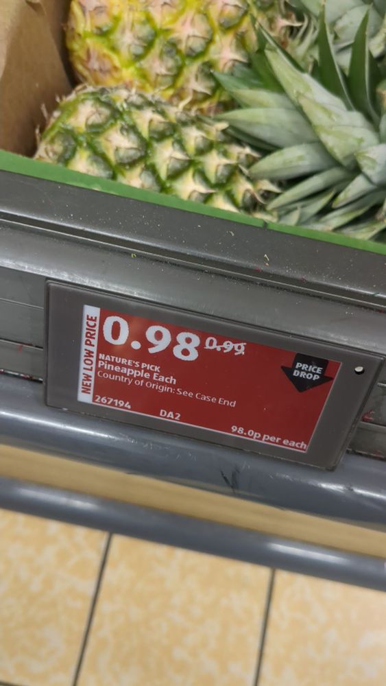 A price label for a pineapple from Aldi. The price has been reduced from 99p to 98p