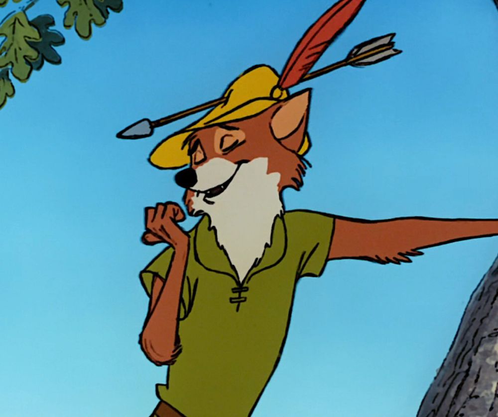 Cartoon fox version of Robin Hood casually leaning against a tree, wearing a green tunic and a slutty little yellow hat with a feather and arrow in it. He’s checking out his nails while delivering a sick burn. All we want is a kind, flirty man who’ll dismantle capitalism with us. 