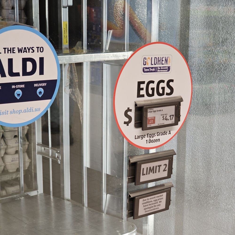 A price tag for a dozen eggs that reads $4.17 per dozen.